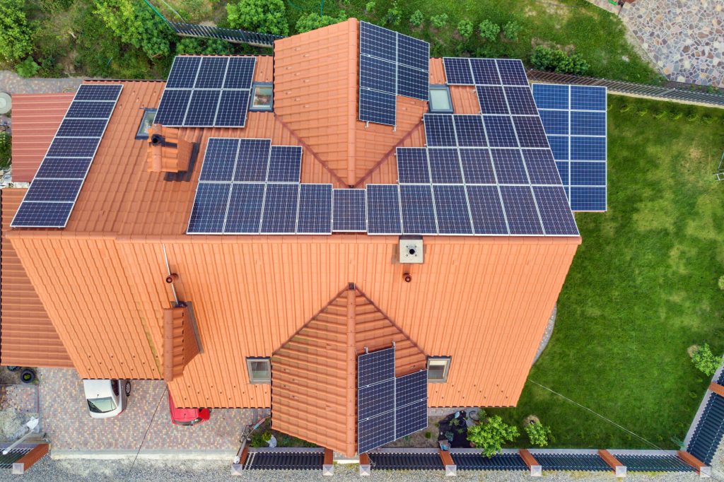 Aerial top view of new modern residential house with solar panels installed